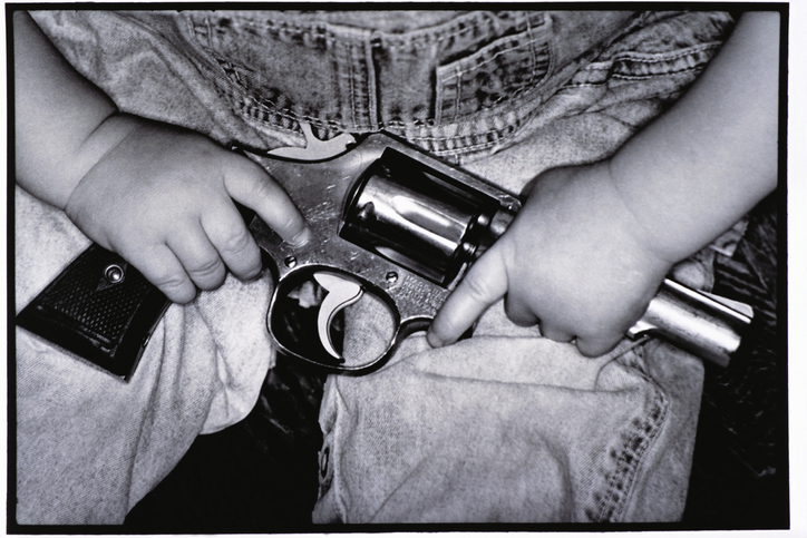 Child Holding Gun