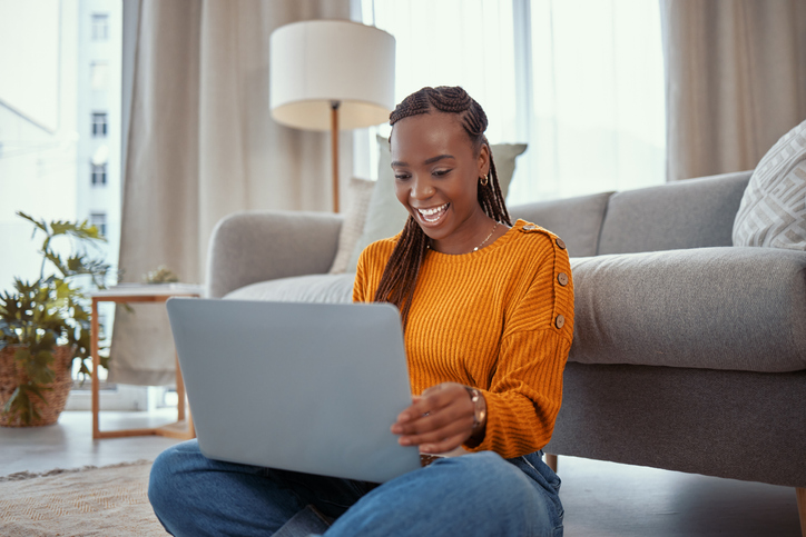Shot of a young woman using a laptop while working from home