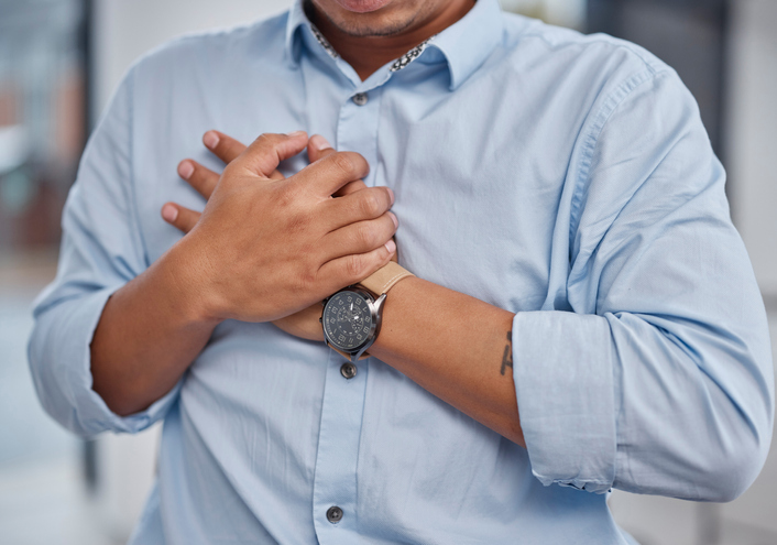 Heart attack, pain and man holding chest in a office with medical, healthcare and emergency. Stress, business and male professional with anxiety and cardiovascular injury from corporate burnout