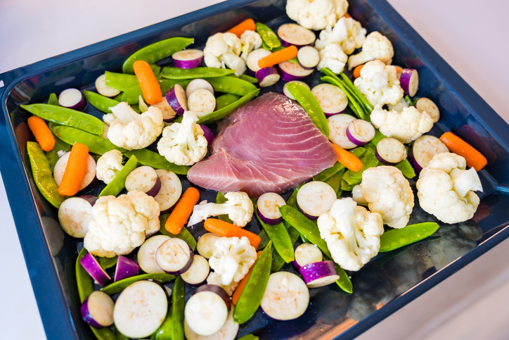 Fresh tuna fillet on a baking sheet with fresh vegetables. Healthy food background. Wallpaper