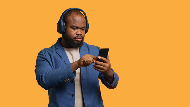 Relaxed person selecting songs from playlist, studio background