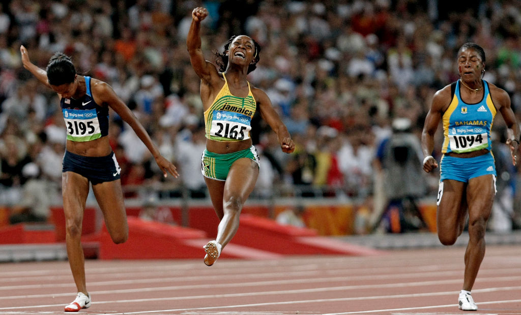 Jamaica's Shelly-Ann Fraser, center, first across the line in the women's 100m to capture the gold medal on Sunday Aug. 17, 2008 at the Olympic Games in Beijing, China, China. USA's Muna Lee, left and Debbie Ferguson-McKenzie, right.